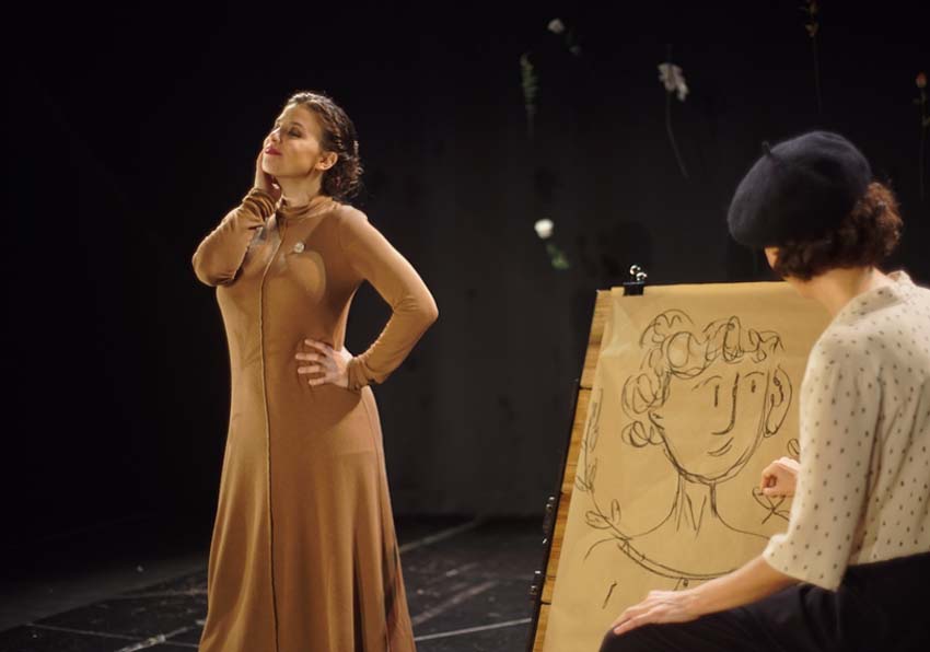 A woman posing and another drawing her